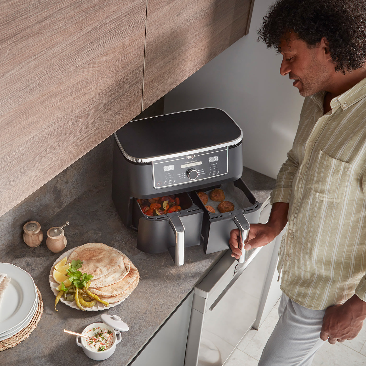 A man using the Ninja Double Drawer Air Fryer
